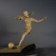 Bronze sculpture of young woman playing soccer