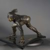 Bronze sculpture of a speed skater in mid turn