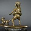 Bronze sculpture of little surfer girl with dog - back side view