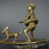Bronze sculpture of little surfer girl with dog - left side view