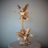 Bronze sculpture of a fairy with butterfly wings on top of a flower - front