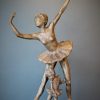 Bronze sculpture of daughter in tutu posing under mother ballerina - front