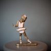 Bronze sculpture of little girl doing a ballet pose in her pink tutu - back side