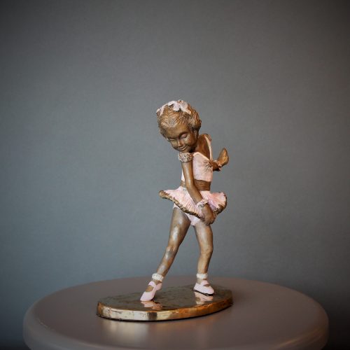 Bronze sculpture of little girl doing a ballet pose in her pink tutu