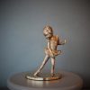 Bronze sculpture of little girl doing a ballet pose in her tutu