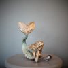 Bronze sculpture of a mermaid and oyster shell with a surprise pearl inside - left side