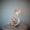 Bronze sculpture of a mermaid and oyster shell with a surprise pearl inside - back side