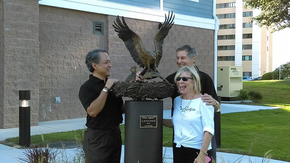 Bronze sculpture of Ospery arriving back at nest.